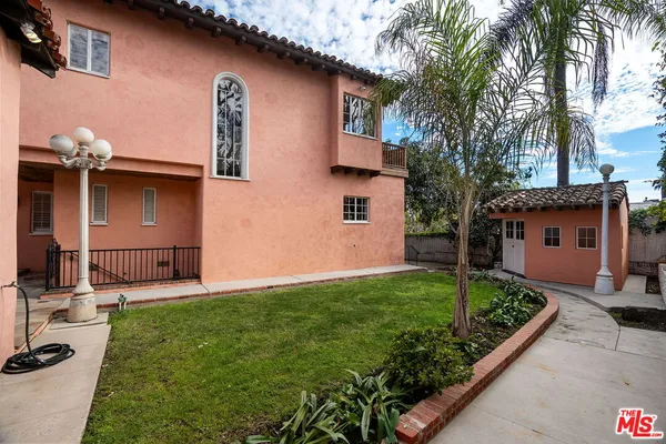 a view of a house with backyard and sitting area