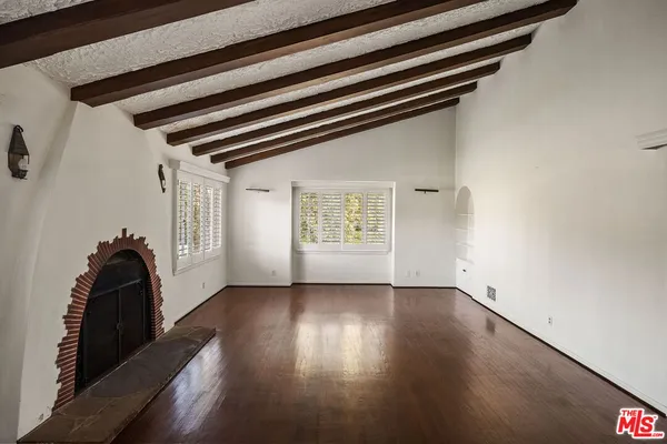 a view of an empty room and wooden floor