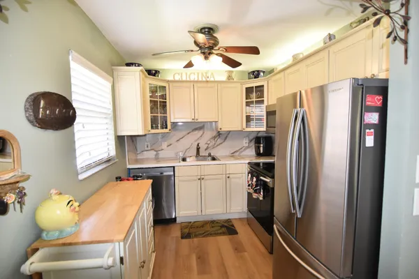 a kitchen with refrigerator a stove a sink and dishwasher