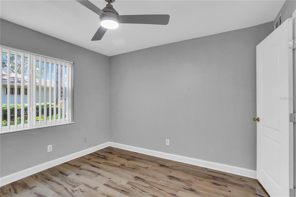 209 Red Cedar Place, Unit 209 Brandon, FL 33510 - Photo 17 of 56 wooden floor in an empty room with a window