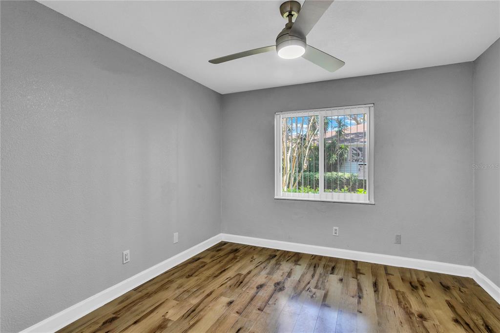 209 Red Cedar Place, Unit 209 Brandon, FL 33510 - Photo 18 of 56 a view of an empty room with wooden floor and a window