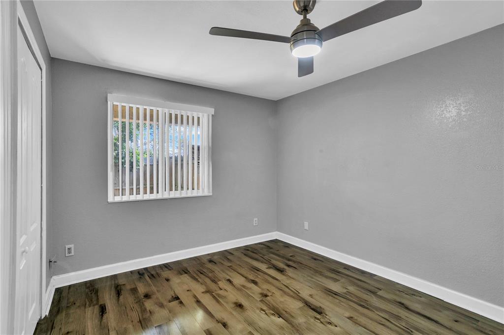 209 Red Cedar Place, Unit 209 Brandon, FL 33510 - Photo 30 of 56 a view of an empty room with wooden floor and a window