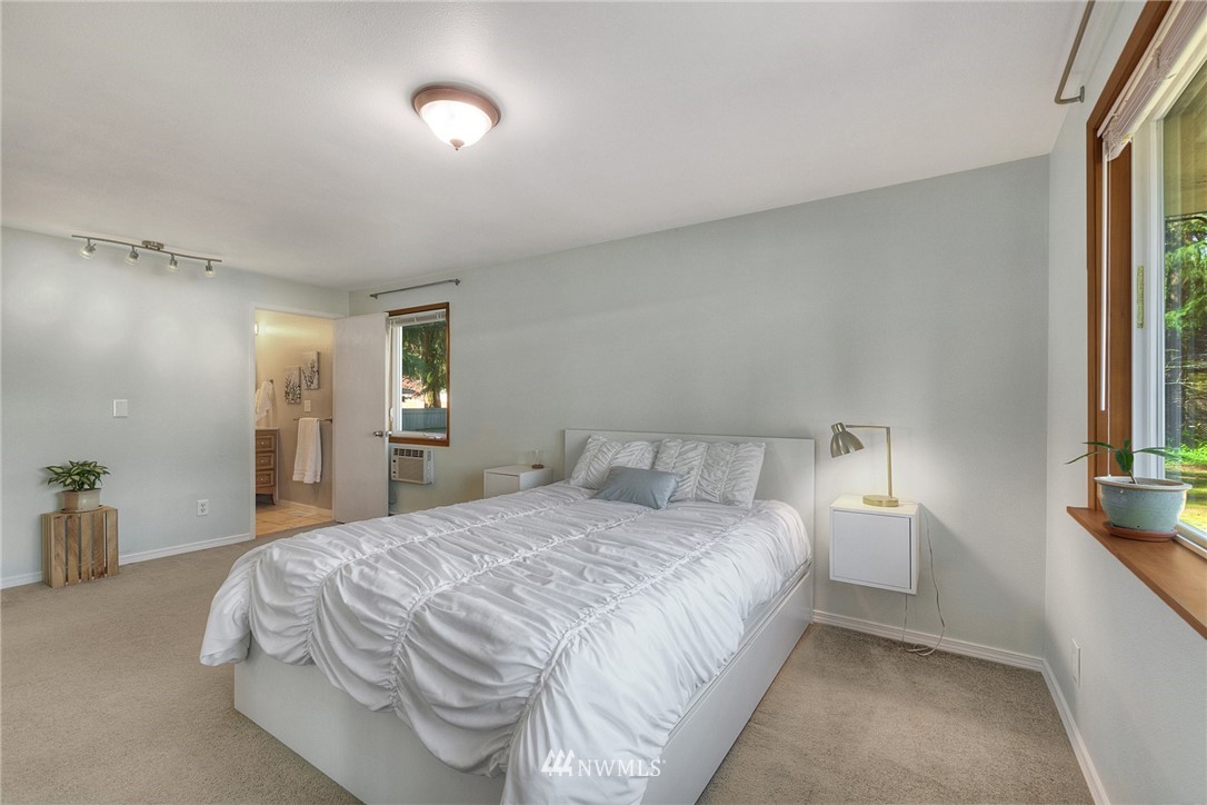 4503 Northeast 17th Place Renton, WA 98059 - Photo 12 of 21 a bedroom with a bed and a lamp