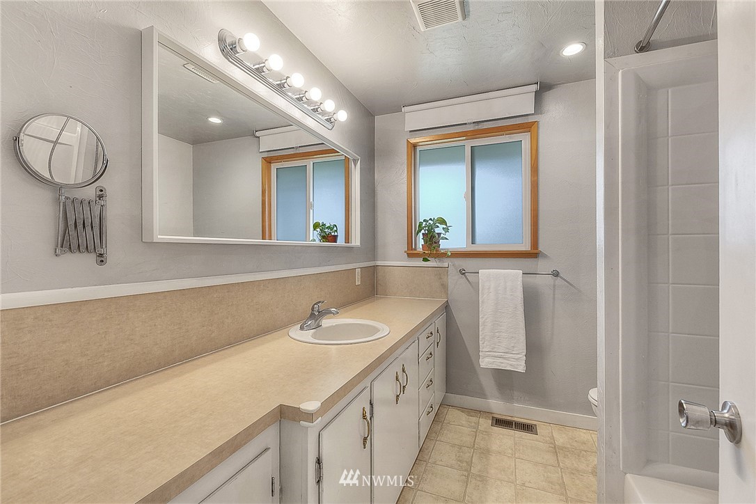 4503 Northeast 17th Place Renton, WA 98059 - Photo 15 of 21 a bathroom with a sink a vanity and a mirror