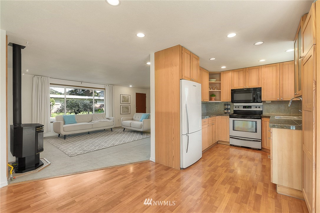 4503 Northeast 17th Place Renton, WA 98059 - Photo 7 of 21 a kitchen with a refrigerator and a stove top oven