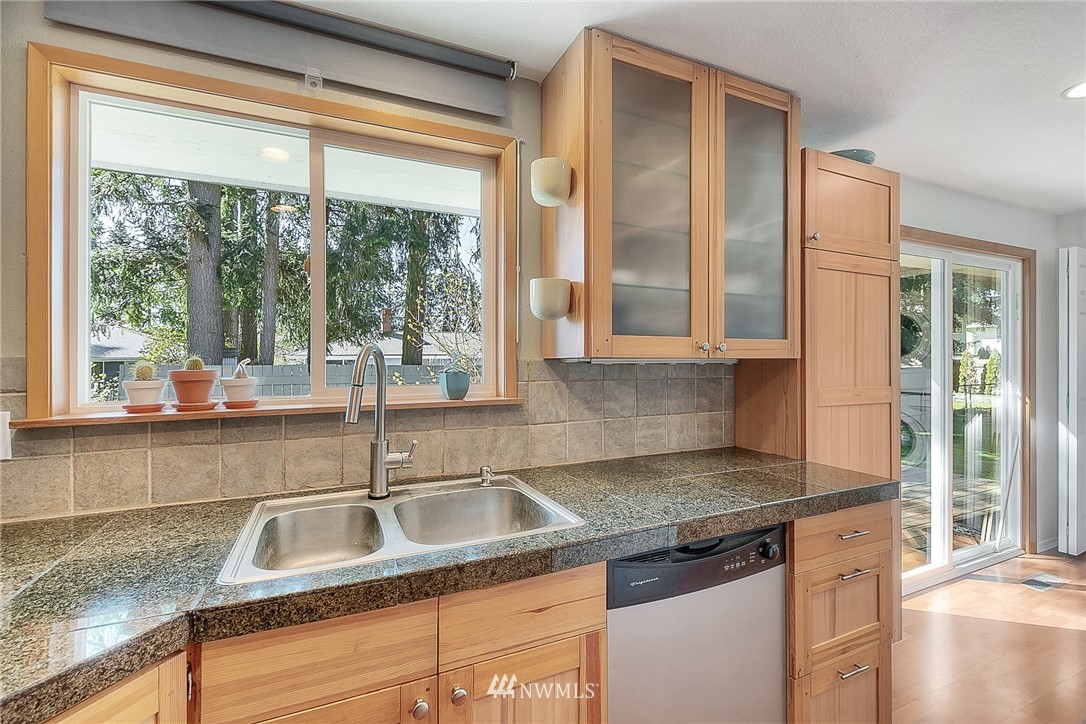 4503 Northeast 17th Place Renton, WA 98059 - Photo 8 of 21 a kitchen with granite countertop a sink and a window