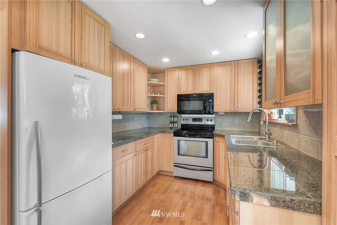 4503 Northeast 17th Place Renton, WA 98059 - Photo 9 of 21 a kitchen with stainless steel appliances a refrigerator sink and microwave