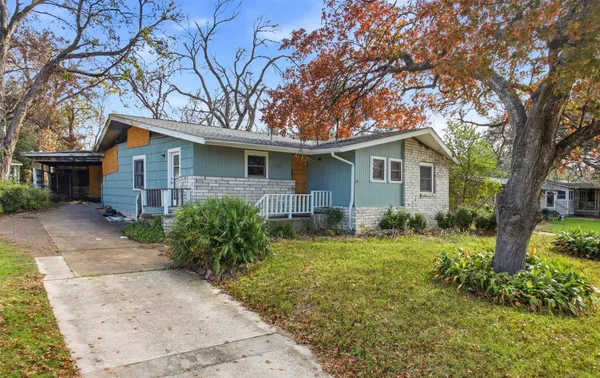 a front view of house with yard and green space