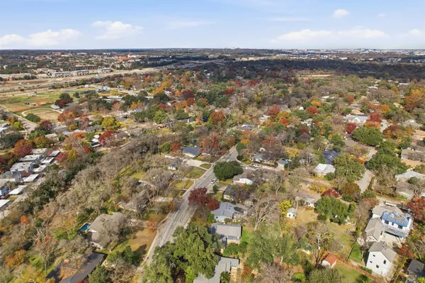 an aerial view of residential houses with city view