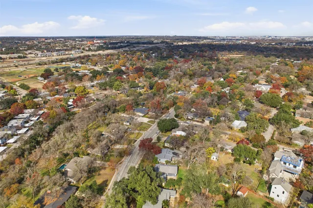 an aerial view of residential houses with city view