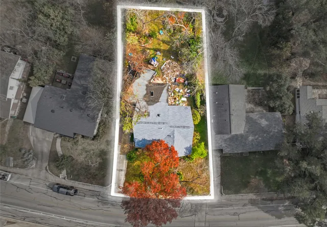 a front view of house with yard and trees around