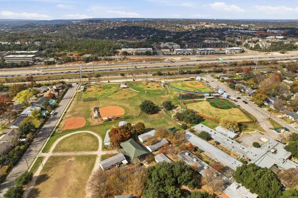 an aerial view of residential houses with city view