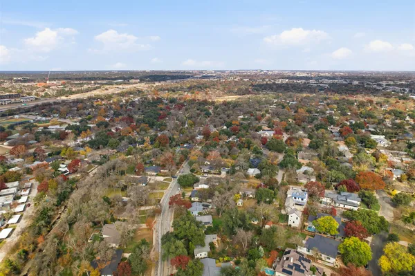 an aerial view of residential houses with city view