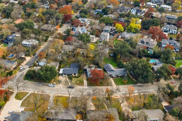 an aerial view of a house with a yard