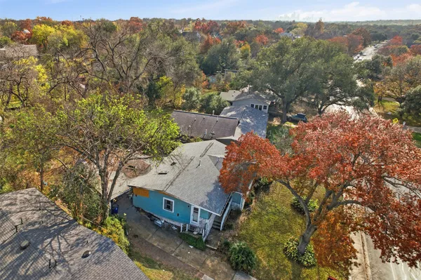 an aerial view of a house with a yard