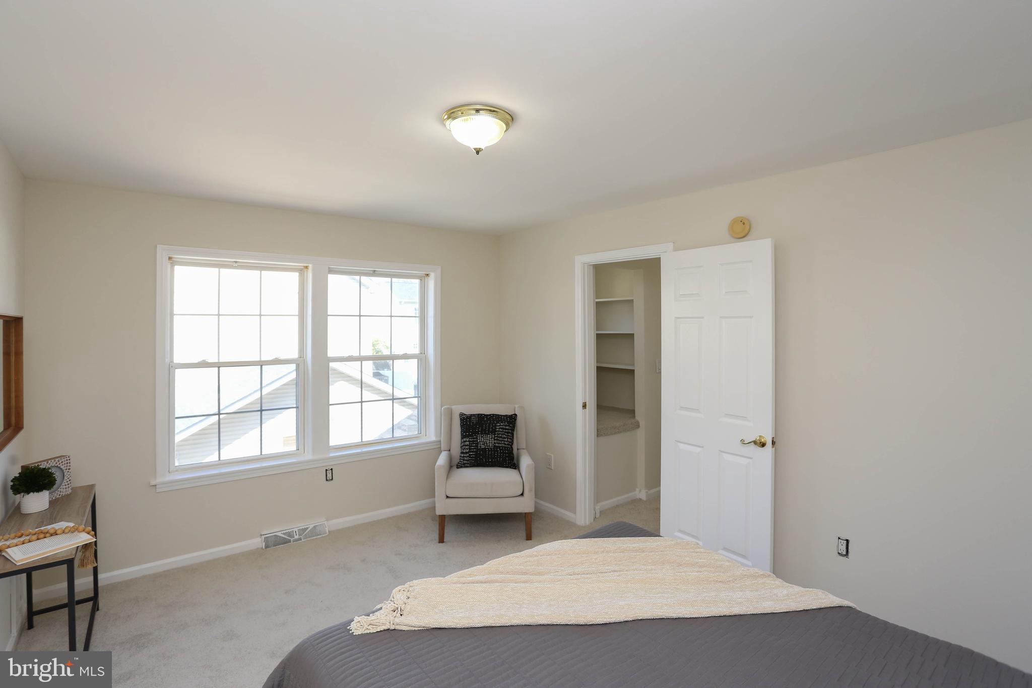 7629 Bluff Point Lane Elkridge, MD 21075 - Photo 14 of 31 a spacious bedroom with a bed and a window