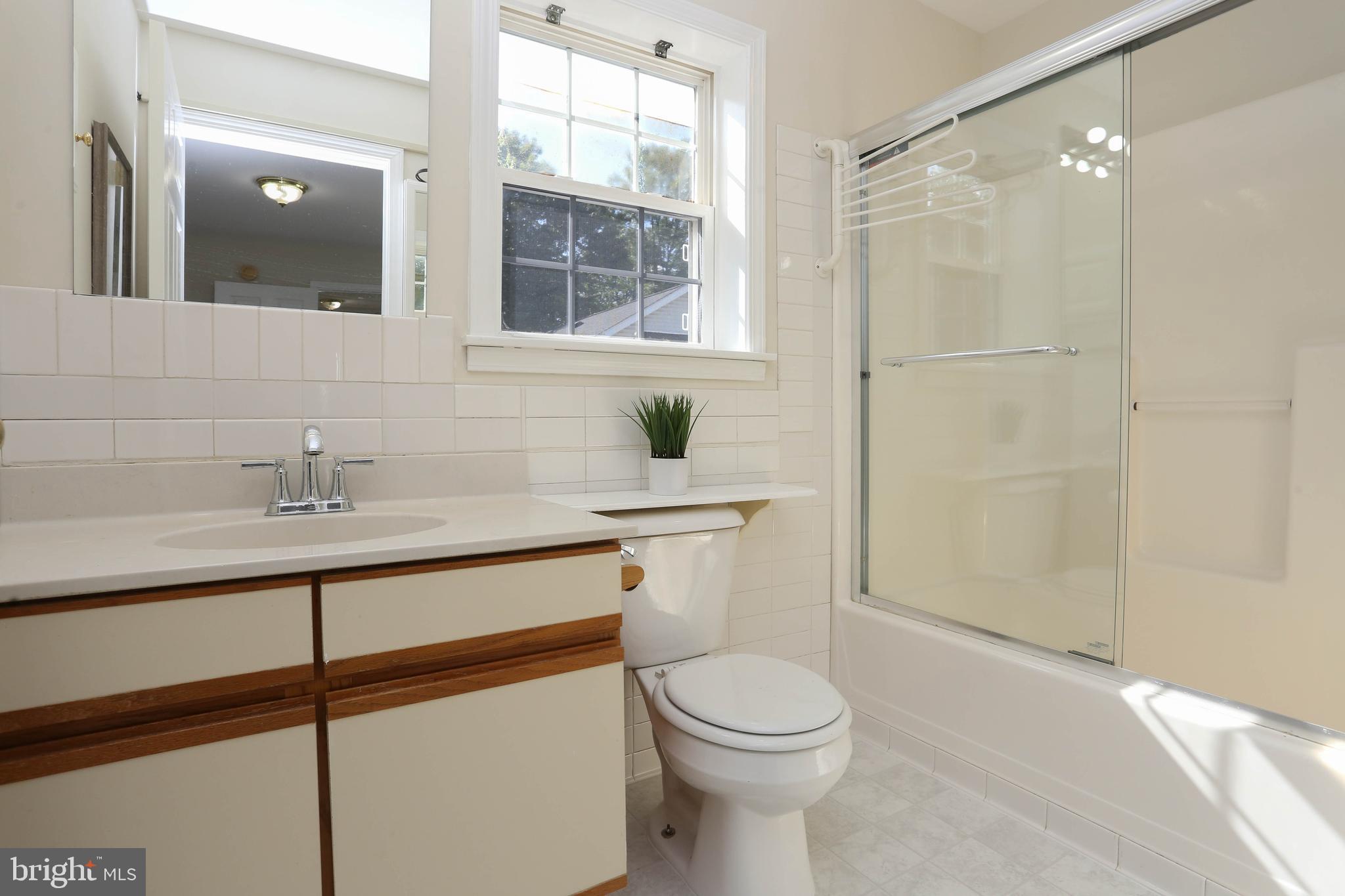 7629 Bluff Point Lane Elkridge, MD 21075 - Photo 15 of 31 a bathroom with a toilet a sink and shower