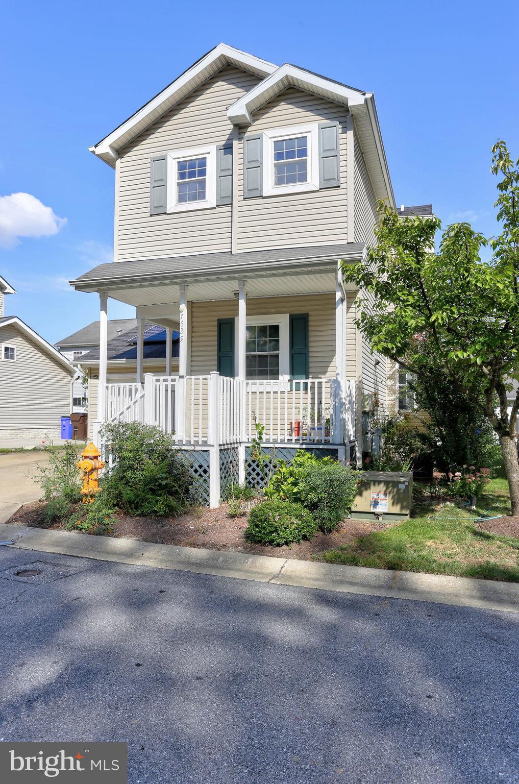 7629 Bluff Point Lane Elkridge, MD 21075 - Photo 26 of 31 a front view of a house with a yard and garage