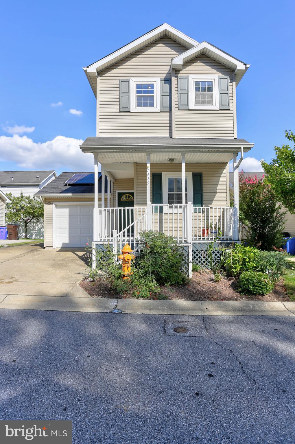 7629 Bluff Point Lane Elkridge, MD 21075 - Photo 27 of 31 a front view of a house with a garden