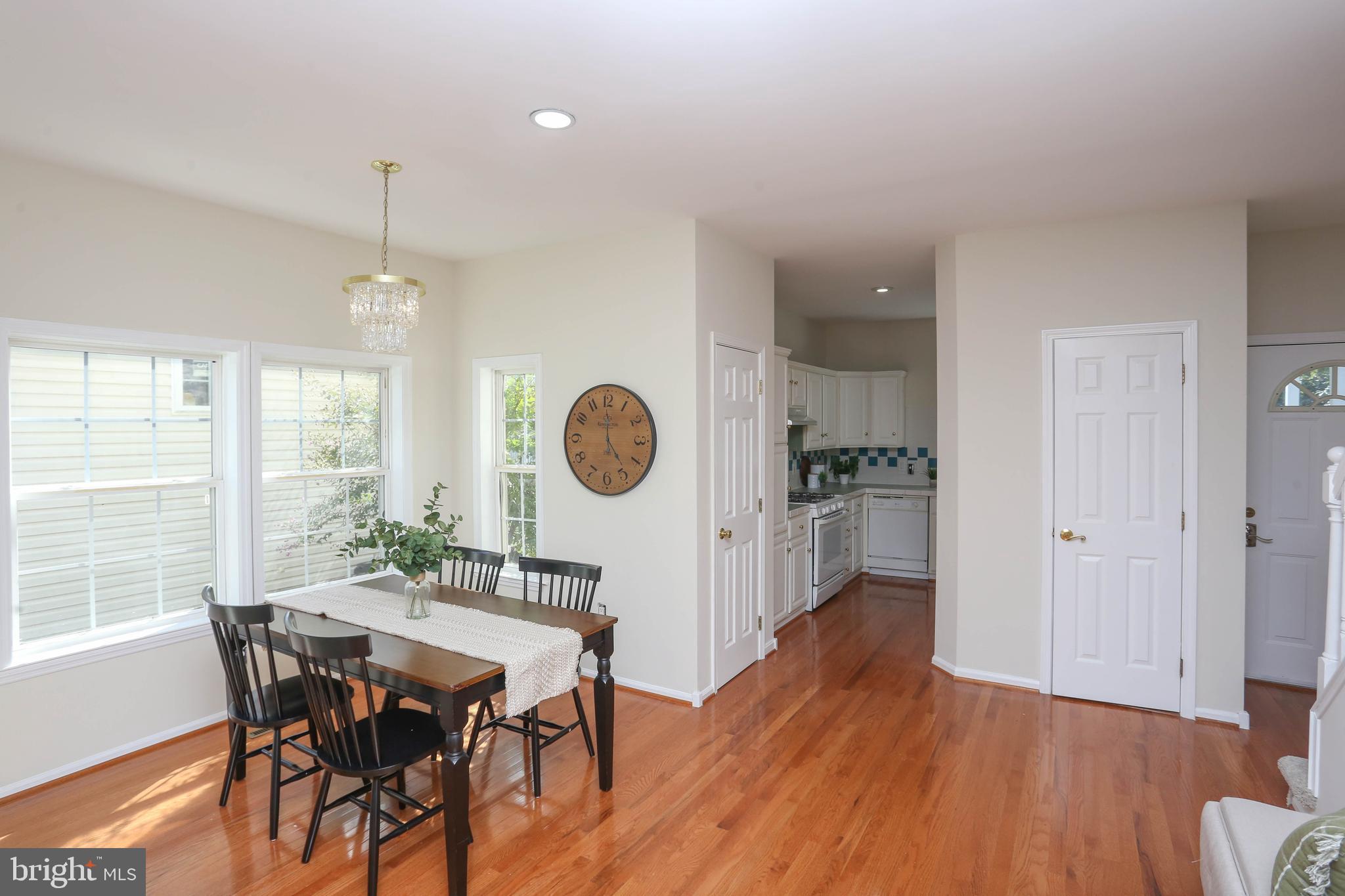 7629 Bluff Point Lane Elkridge, MD 21075 - Photo 3 of 31 a view of a dining room with furniture window and wooden floor
