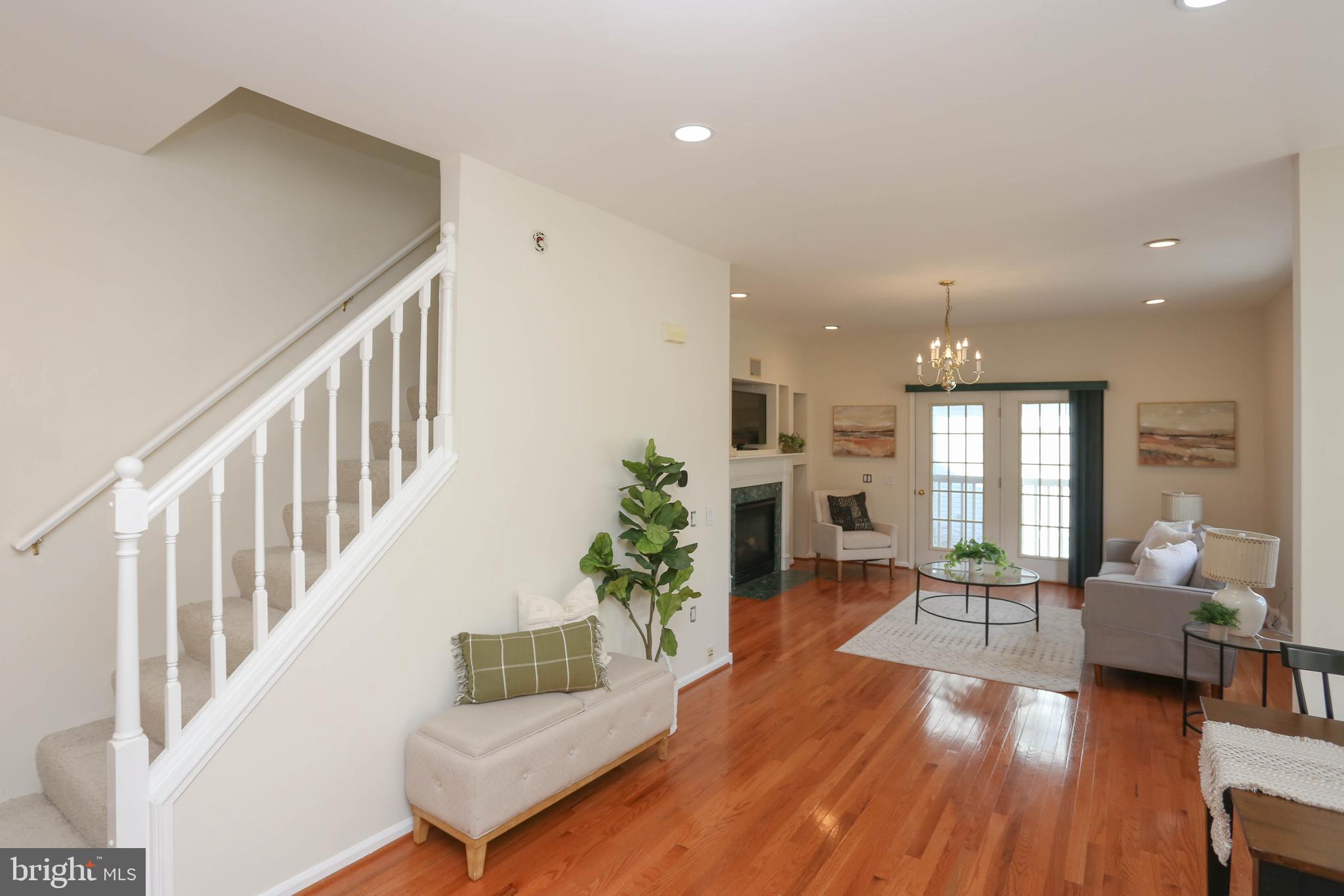 7629 Bluff Point Lane Elkridge, MD 21075 - Photo 6 of 31 a living room with furniture fireplace and potted plants with wooden floor