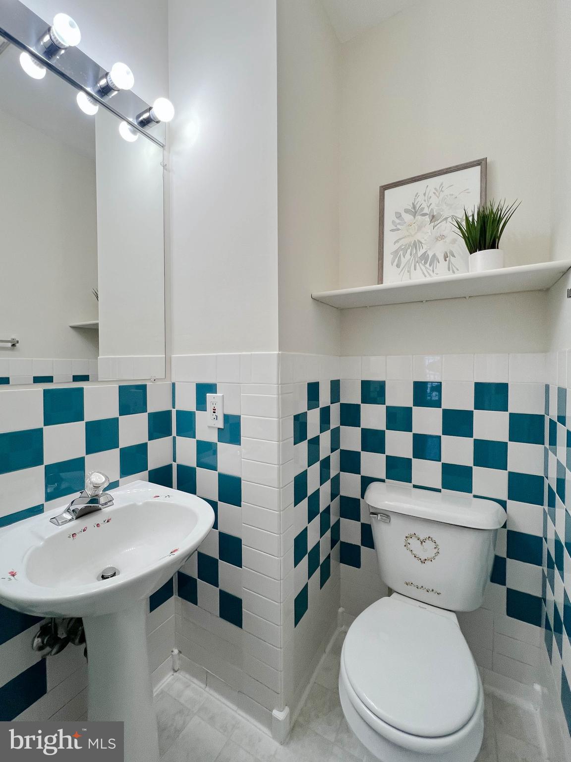 7629 Bluff Point Lane Elkridge, MD 21075 - Photo 10 of 31 a bathroom with a sink a toilet and a mirror