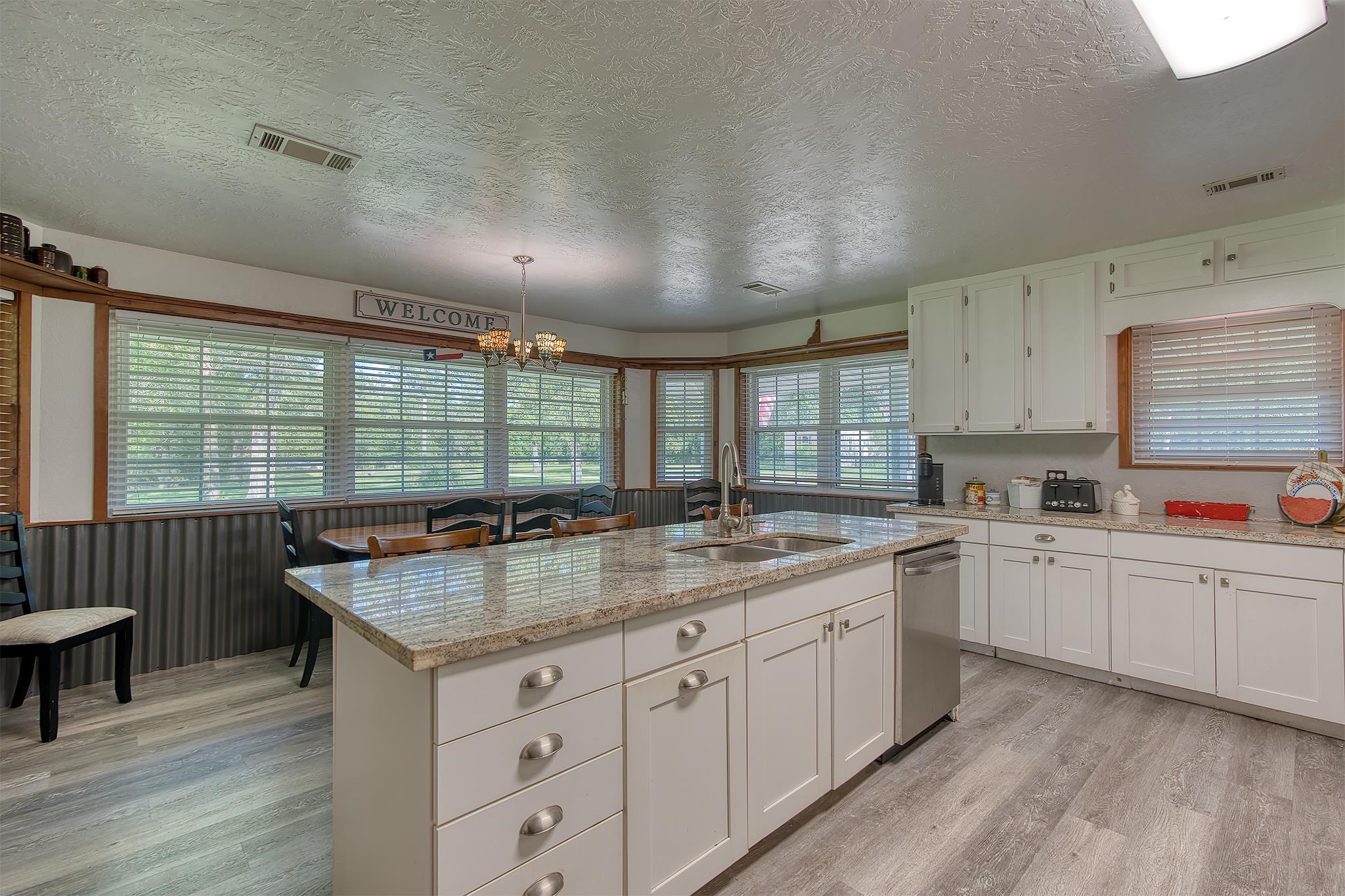 7476 Foard Road Beaumont, TX 77705 - Photo 15 of 49 a kitchen with granite countertop a sink and cabinets