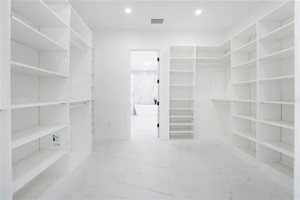a spacious bathroom with a double vanity sink a mirror and a bathtub