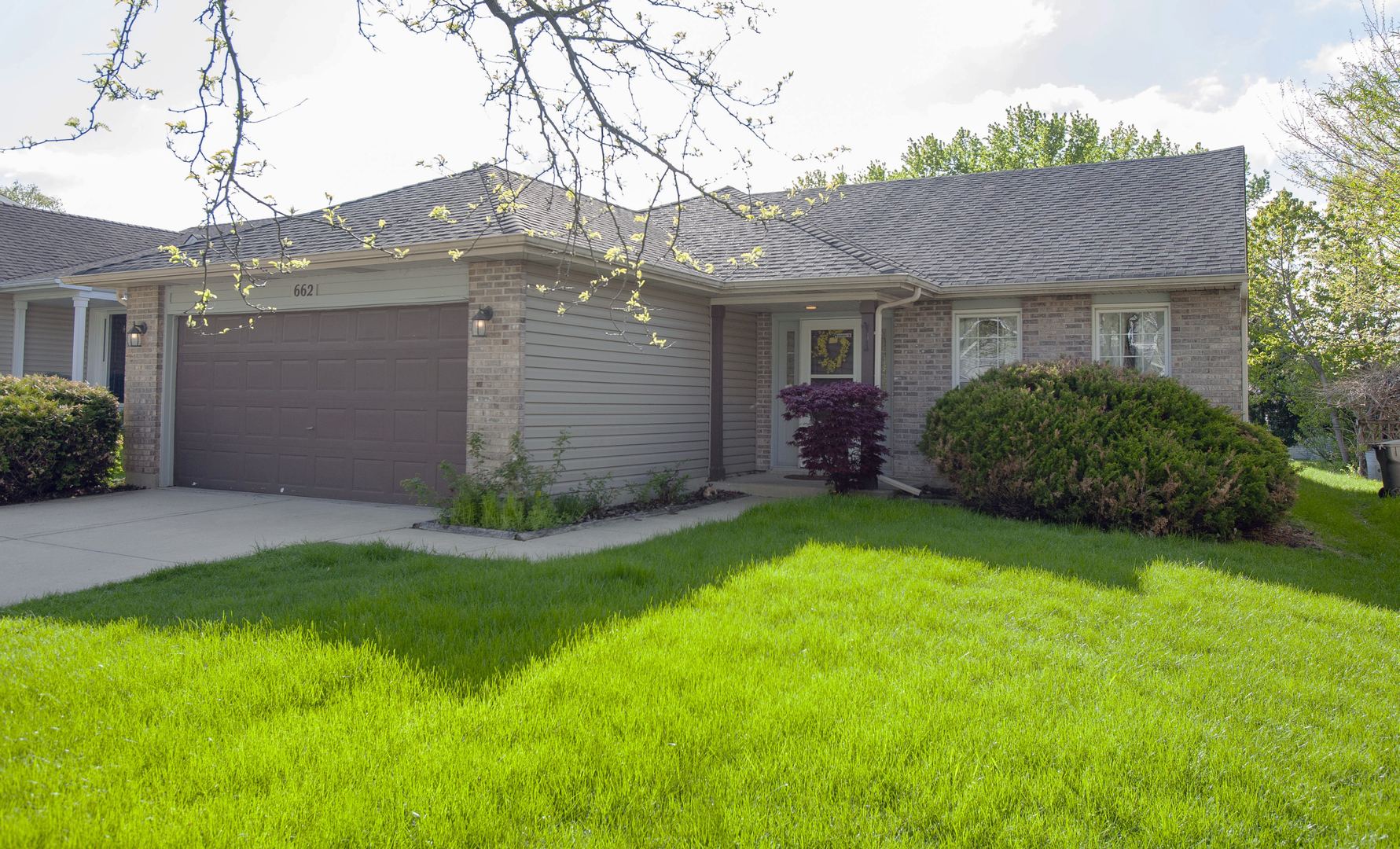 a front view of a house with a garden