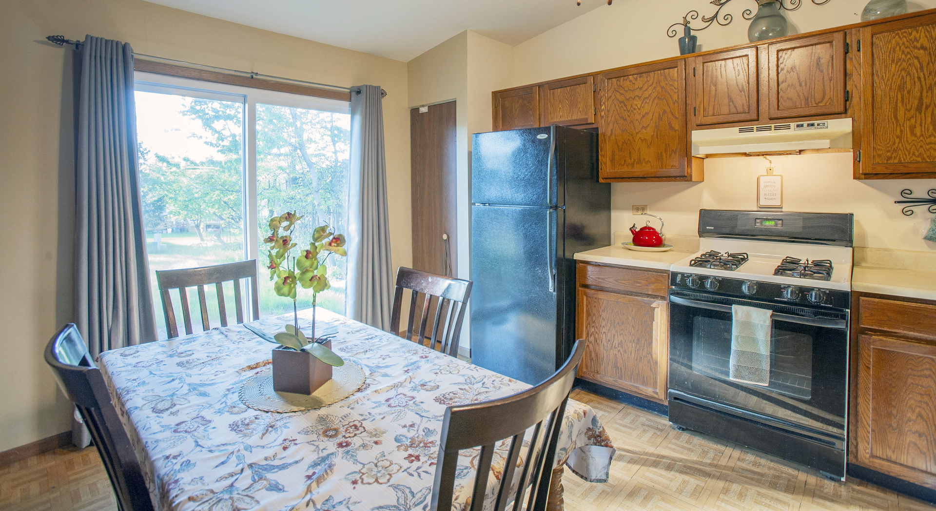 662 Dover Drive Elgin, IL 60120 - Photo 23 of 23 a kitchen with stainless steel appliances granite countertop a refrigerator a stove a sink a dining table and chairs