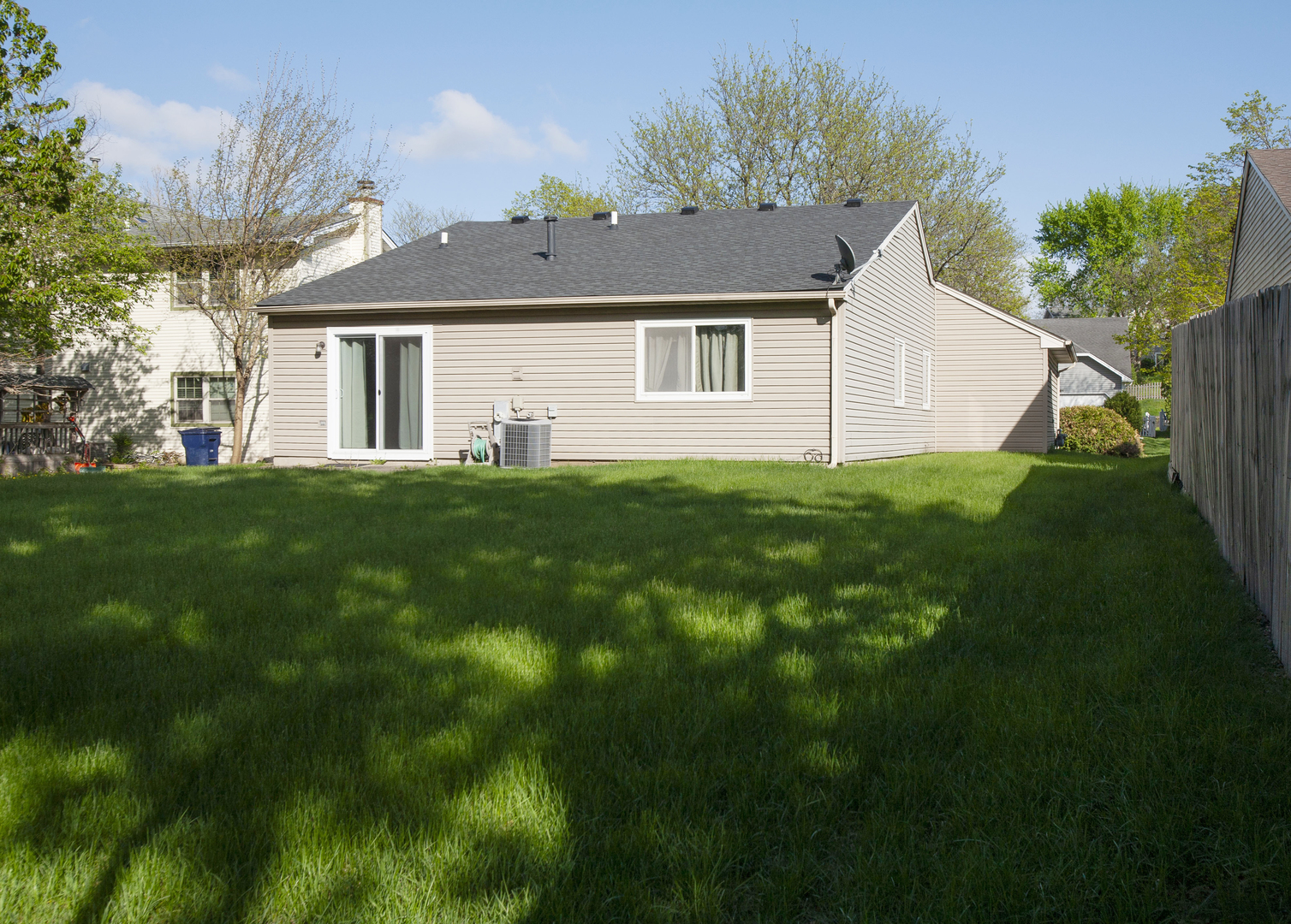 662 Dover Drive Elgin, IL 60120 - Photo 3 of 23 a view of a yard in front of a house with plants and large tree