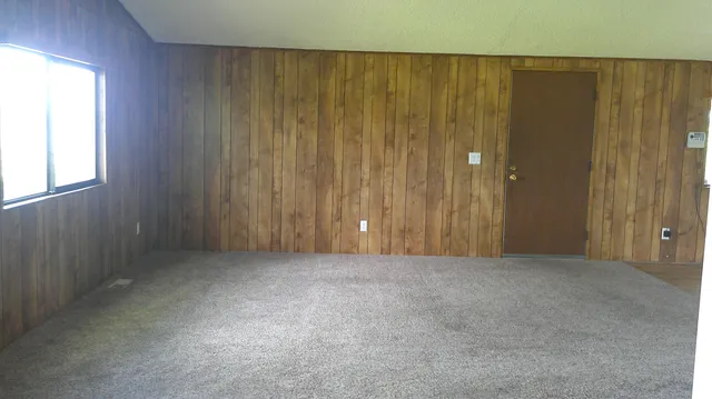 a view of a hallway with wooden floor and entryway