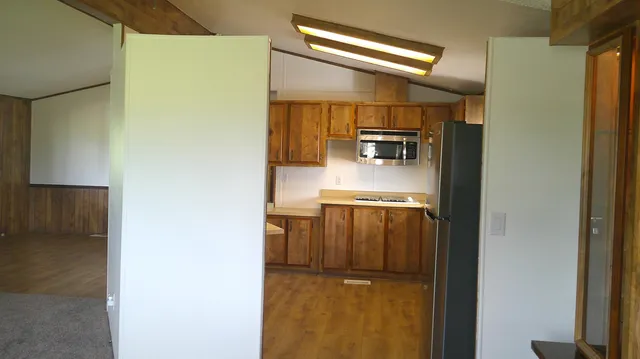 a kitchen with a sink a stove and a refrigerator