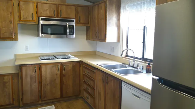 a kitchen with a refrigerator and a sink