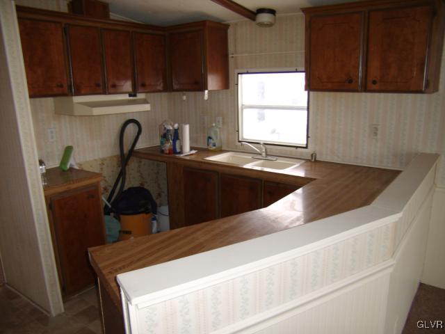 3101 Newburg Road Nazareth, PA 18064 - Photo 6 of 10 a kitchen with a sink a stove a microwave and cabinets