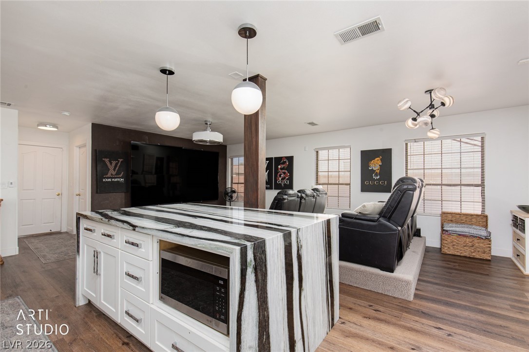387 Silver Road Mesquite, NV 89027 - Photo 13 of 46 Rich wood floors and a striking stone island ground this open interior layout.