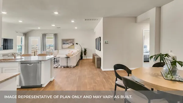 a living room with furniture a dining table and kitchen view
