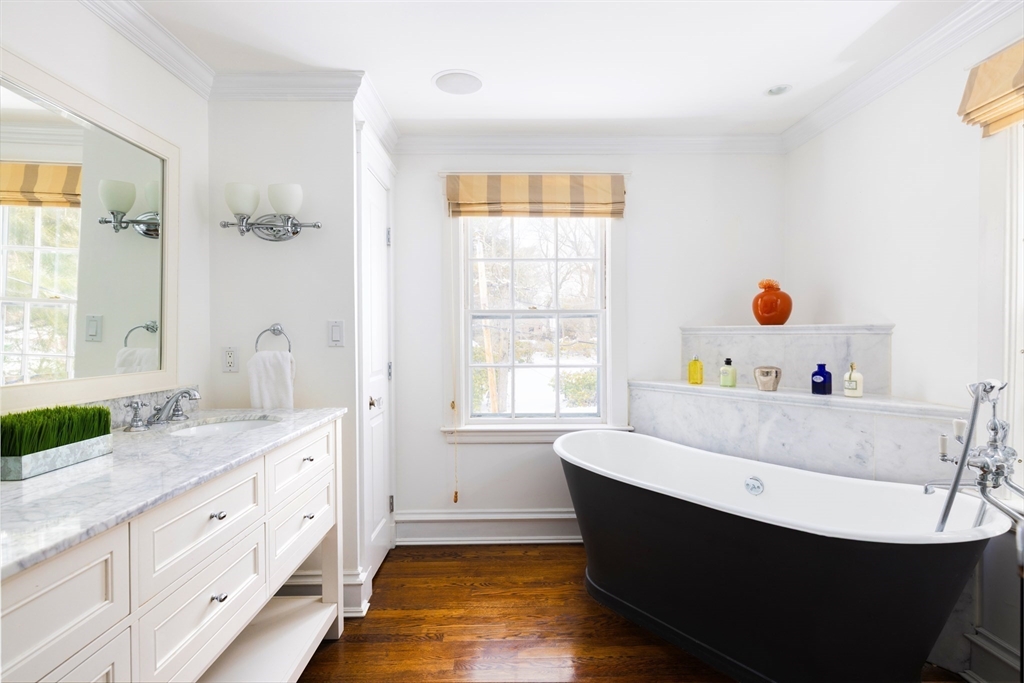 18 Moffat Road Newton, MA 02468 - Photo 11 of 23 a bathroom with a double vanity sink a mirror and a bathtub