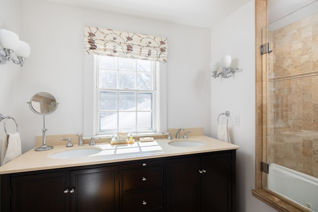 18 Moffat Road Newton, MA 02468 - Photo 14 of 23 a bathroom with a double vanity sink and a mirror