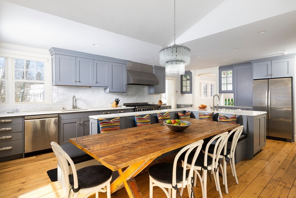 18 Moffat Road Newton, MA 02468 - Photo 8 of 23 a kitchen with a dining table chairs stainless steel appliances and cabinets