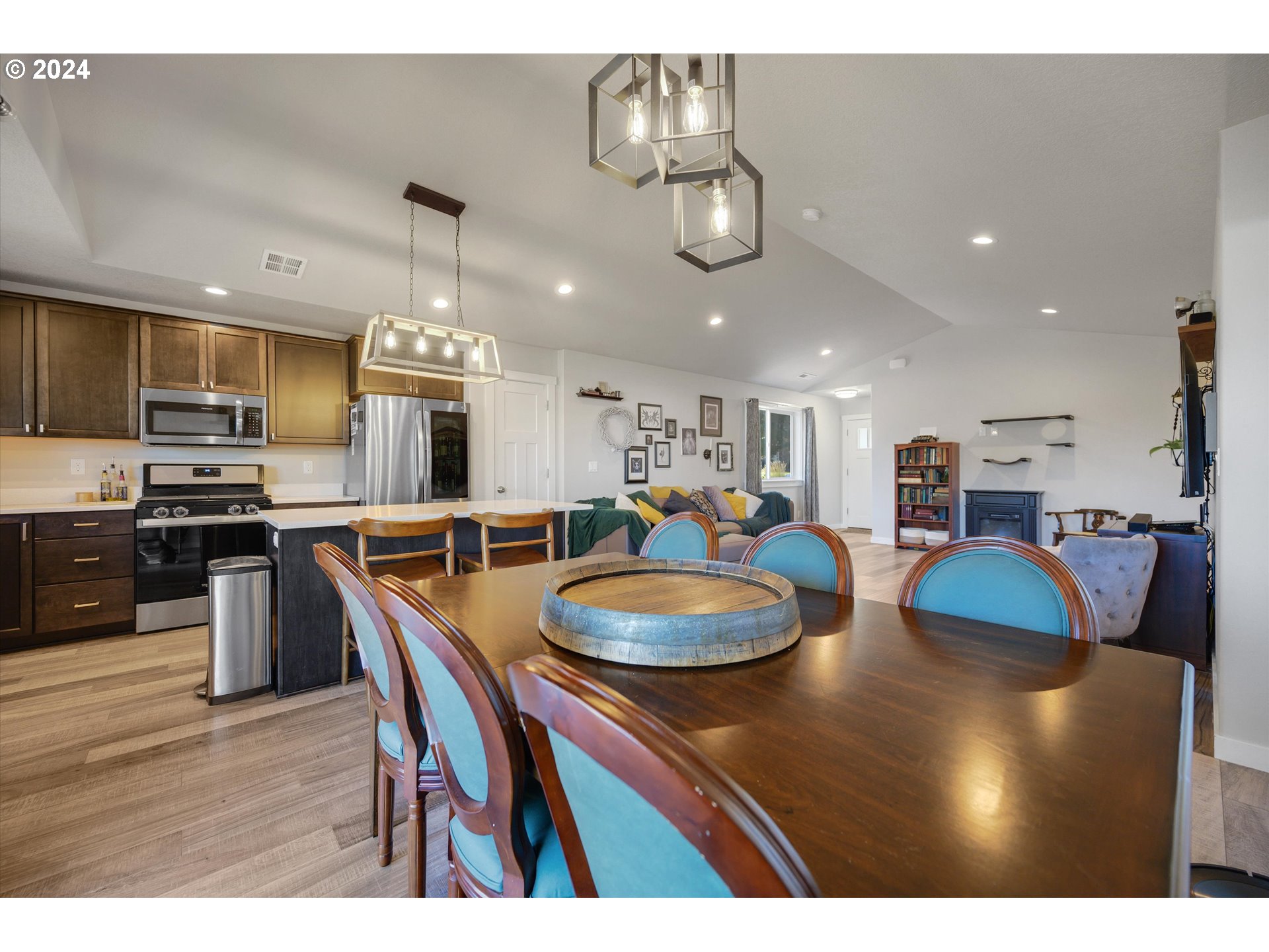 1326 Southwest 9th Street Dallas, OR 97338 - Photo 18 of 32 a kitchen with stainless steel appliances granite countertop a sink dishwasher a dining table and chairs with wooden floor