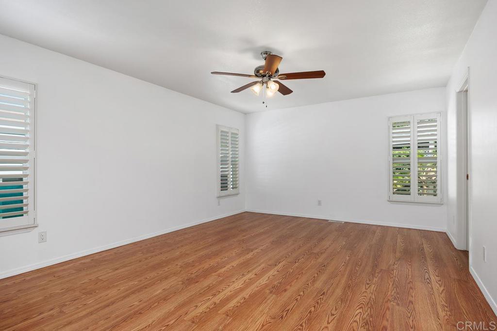 5144 Don Ricardo Drive Carlsbad, CA 92010 - Photo 14 of 34 a view of empty room with wooden floor and fan