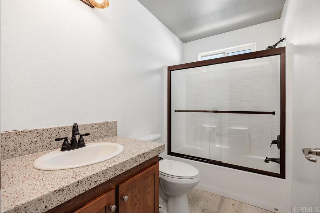 5144 Don Ricardo Drive Carlsbad, CA 92010 - Photo 20 of 34 a bathroom with a granite countertop sink mirror vanity and toilet