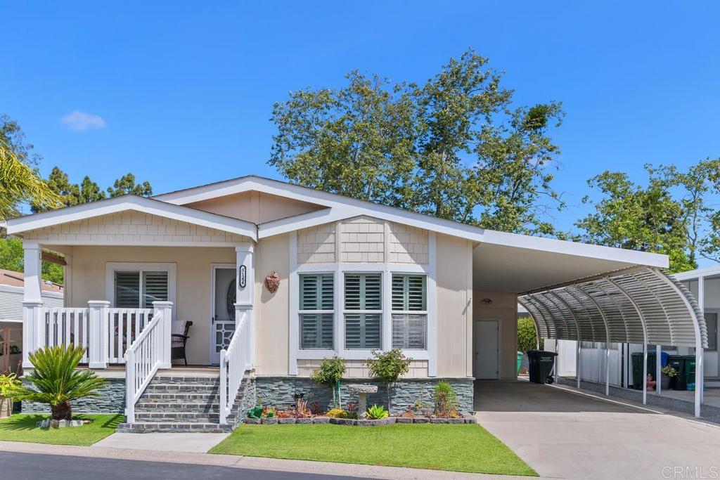 5144 Don Ricardo Drive Carlsbad, CA 92010 - Photo 2 of 34 a front view of a house with garden