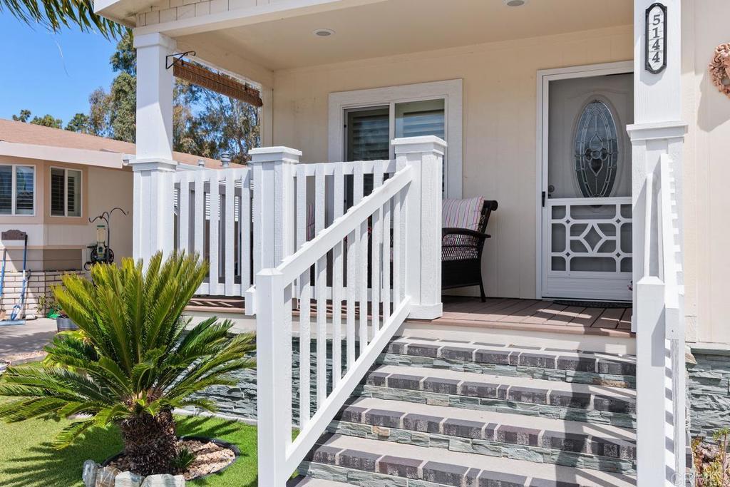 5144 Don Ricardo Drive Carlsbad, CA 92010 - Photo 3 of 34 a view of staircase with wooden floor and a potted plant