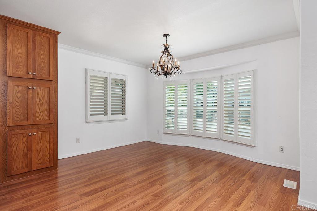 5144 Don Ricardo Drive Carlsbad, CA 92010 - Photo 7 of 34 a view of an empty room with wooden floor and a window