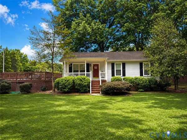 a view of a house with a backyard and a tree