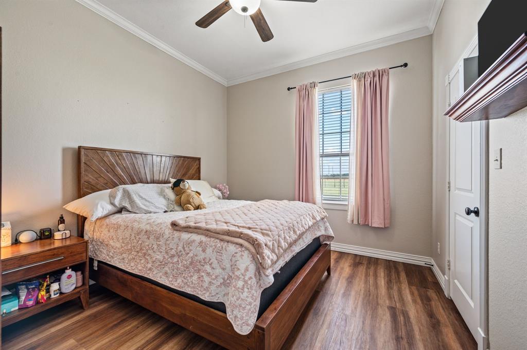 1216 W Road Waxahachie, TX 75165 - Photo 20 of 40 a bed sitting in a bedroom next to a window