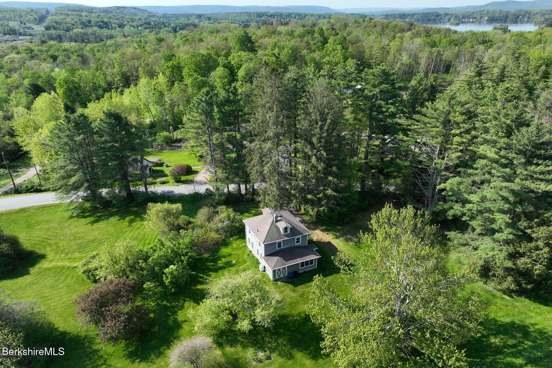 86 Miner Road Lanesborough, MA 01237 - Photo 15 of 44 a backyard of a house with a yard and outdoor seating