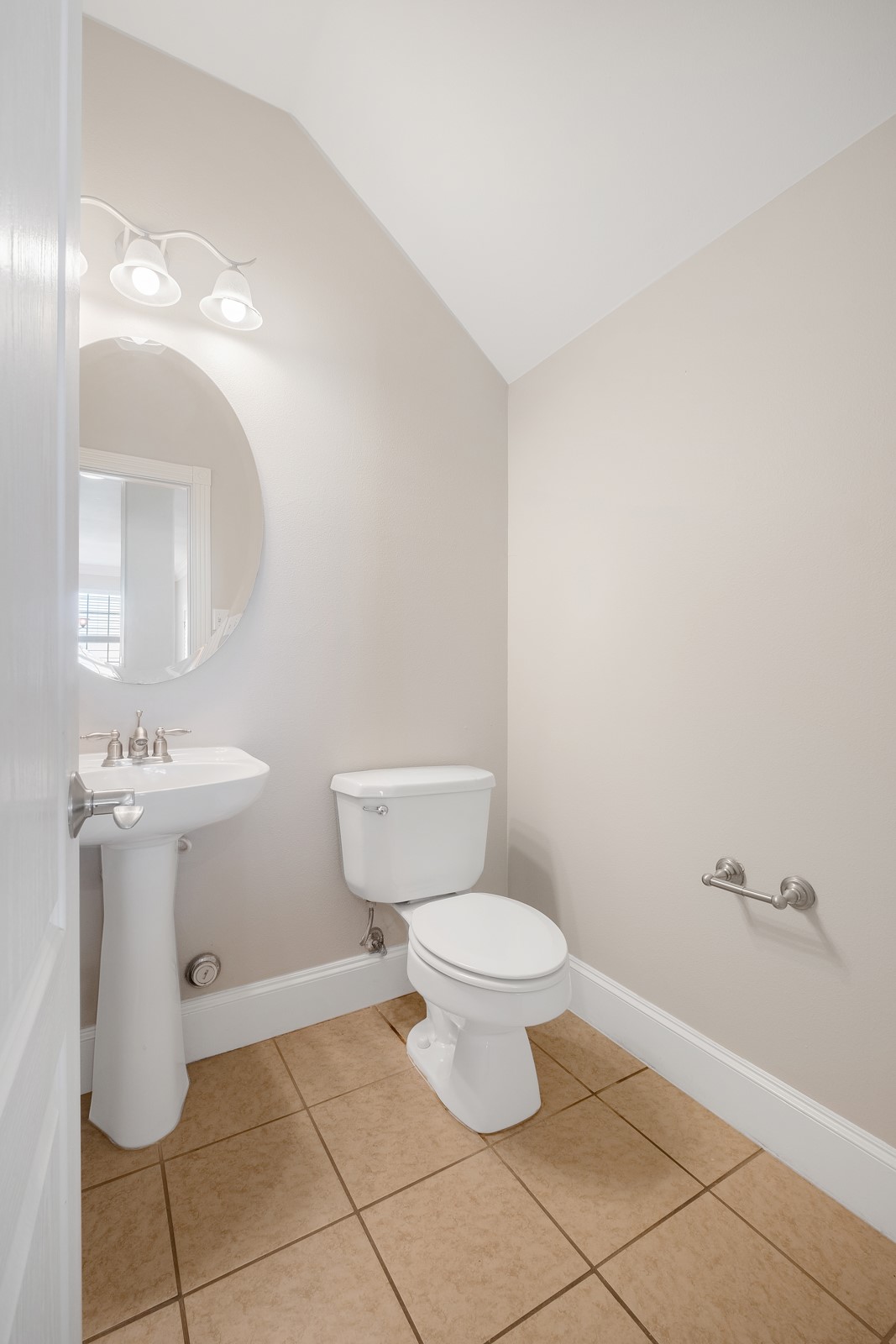 6715 Windrift Way, Unit 8 Austin, TX 78745 - Photo 11 of 24 A compact and well-appointed powder room features neutral walls and practical tile flooring.
